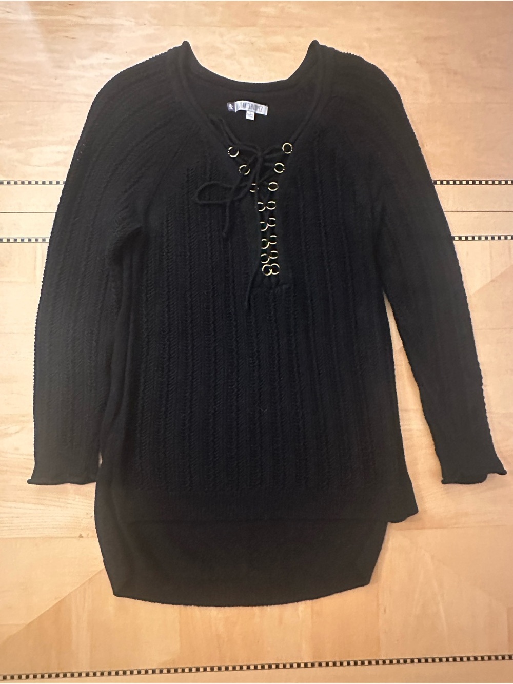 Jennifer Lopez Black Sweater with Gold Eyelet Detail